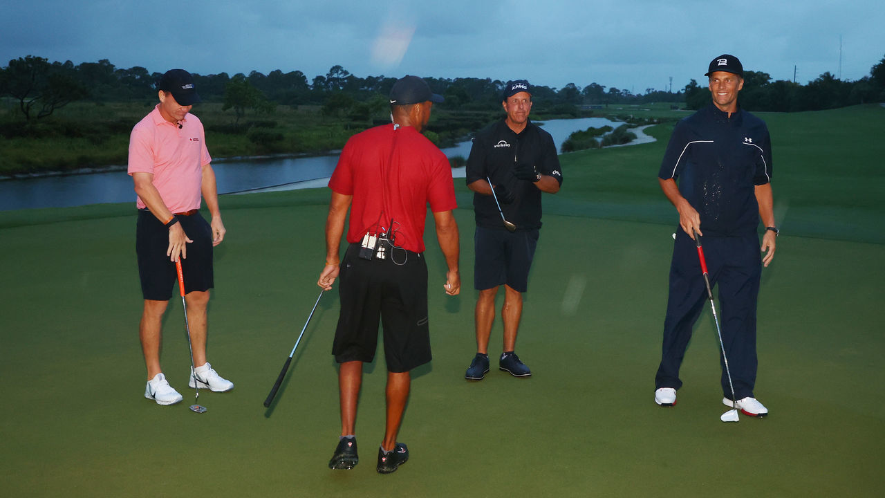 HOBE SOUND, FLORIDA - MAY 24: Tiger Woods and former NFL player Peyton Manning celebrate defeating Phil Mickelson and NFL player Tom Brady of the Tampa Bay Buccaneers on the 18th green during The Match: Champions For Charity at Medalist Golf Club on May 24, 2020 in Hobe Sound, Florida.