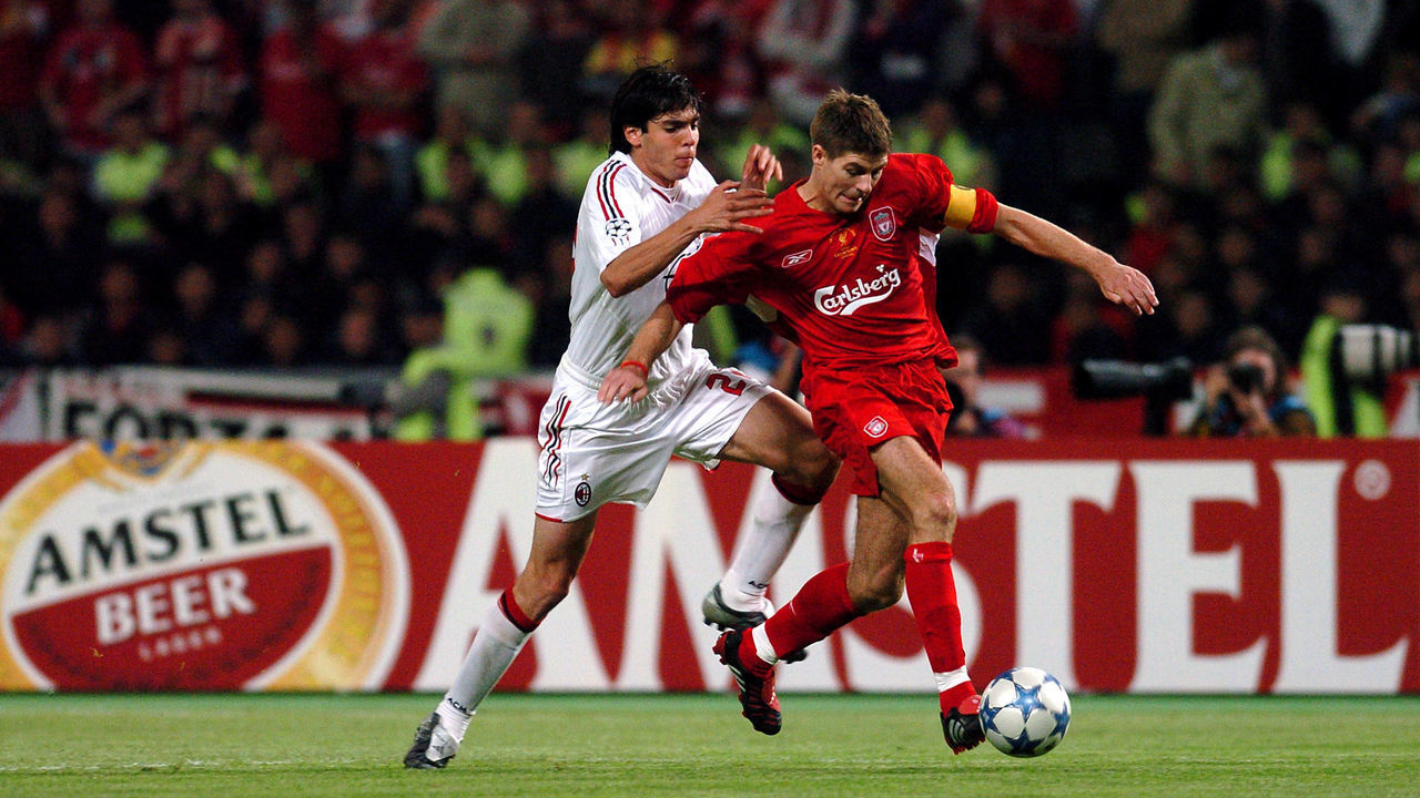 Liverpool's Steven Gerrard (r) holds off the challenge by AC Milan's Kaka