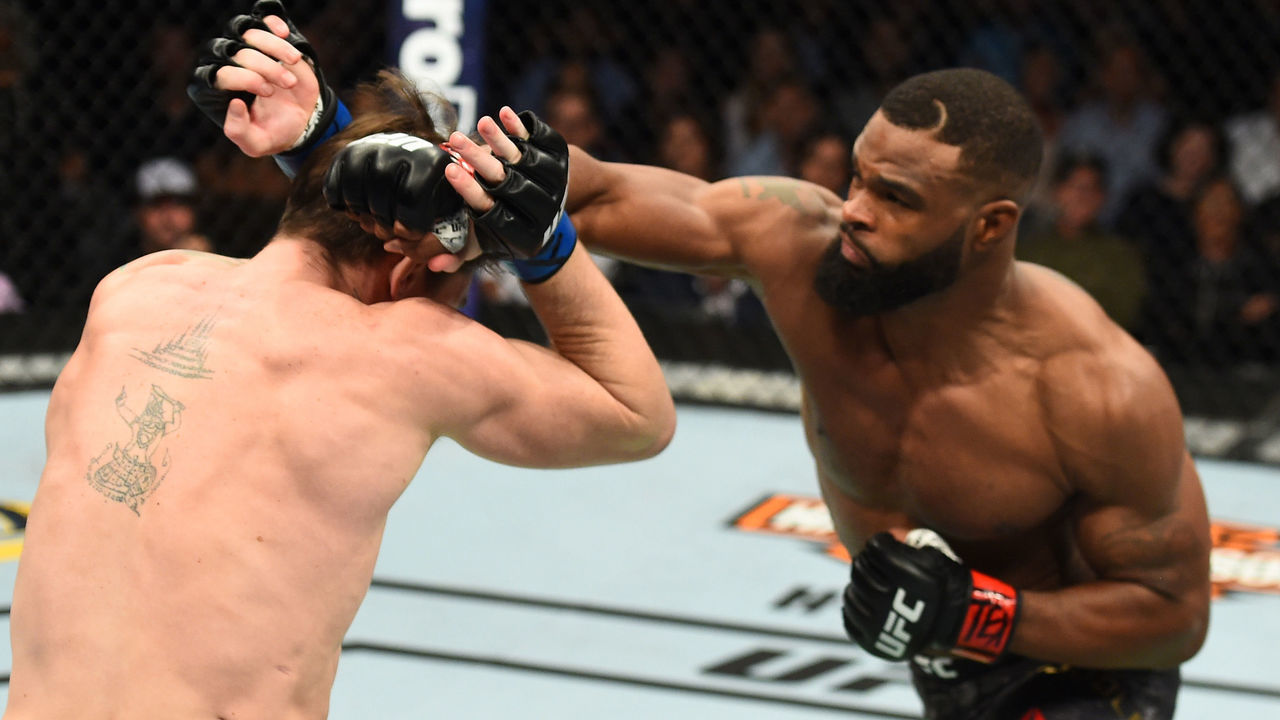 DALLAS, TX - SEPTEMBER 08: (R-L) Tyron Woodley punches Darren Till of England in their UFC welterweight championship fight during the UFC 228 event at American Airlines Center on September 8, 2018 in Dallas, Texas.