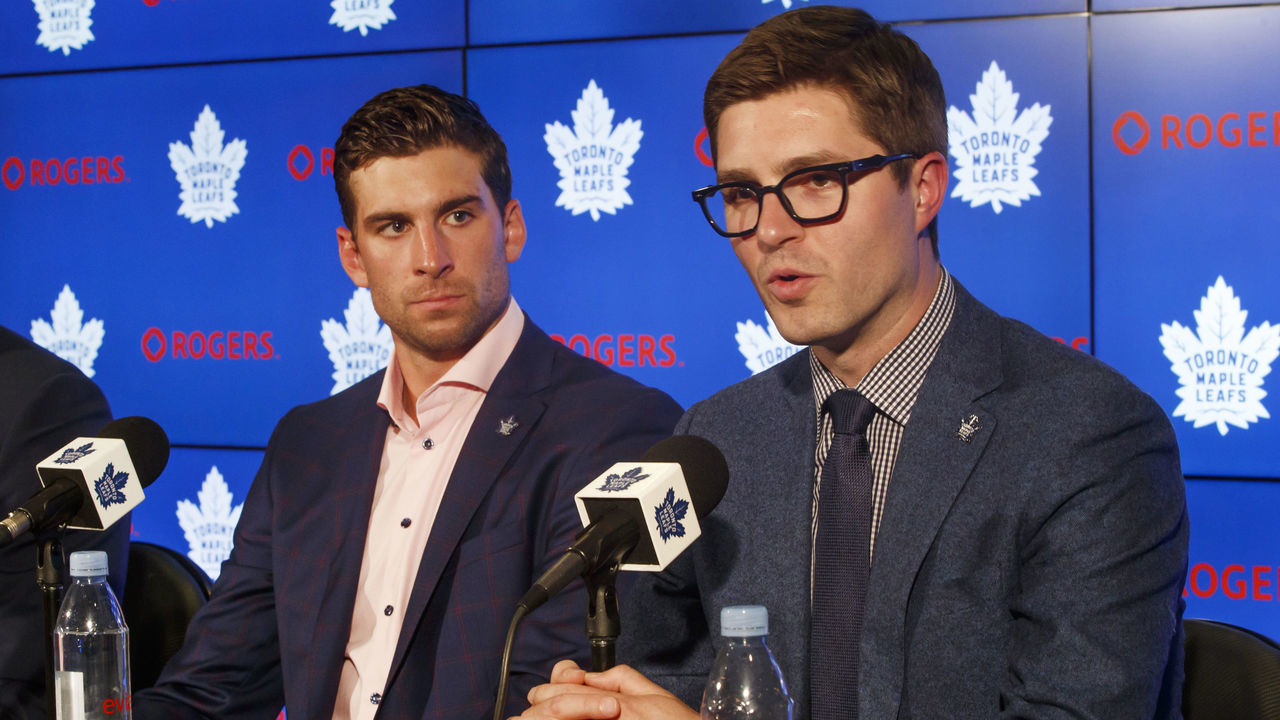 TORONTO, ON - JULY 1: Kyle Dubas, General Manager of the Toronto Maple Leafs speaks at a press conference about signing free agent, John Tavares #91 of the Toronto Maple Leafs, as Brendan Shanahan, President of the Toronto Maple Leafs, looks on, at the Scotiabank Arena on July 1, 2018 in Toronto, Ontario, Canada.
