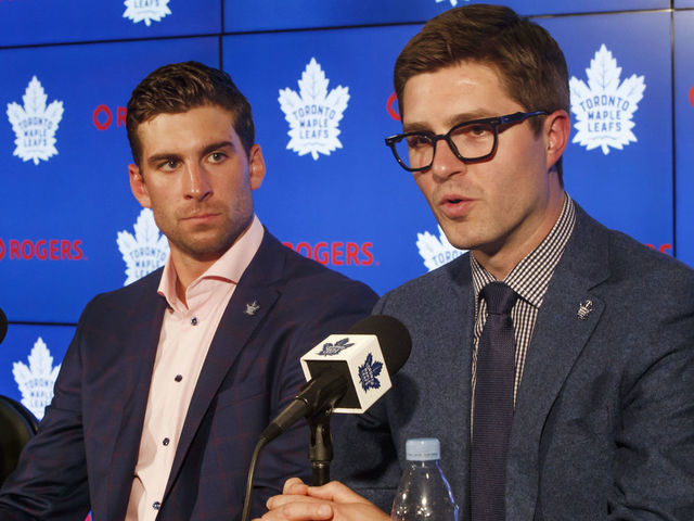 TORONTO, ON - JULY 1: Kyle Dubas, General Manager of the Toronto Maple Leafs speaks at a press conference about signing free agent, John Tavares #91 of the Toronto Maple Leafs, as Brendan Shanahan, President of the Toronto Maple Leafs, looks on, at the Scotiabank Arena on July 1, 2018 in Toronto, Ontario, Canada.