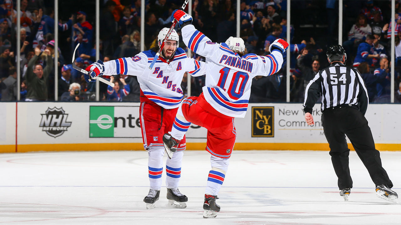 NEW YORK, NEW YORK - FEBRUARY 25: Mika Zibanejad #93 of the New York Rangers is congratulated by his teammate Artemi Panarin #10 after scoring the game-winning goal against the New York Islanders during overtime at NYCB Live's Nassau Coliseum on February 25, 2020 in Uniondale, New York.