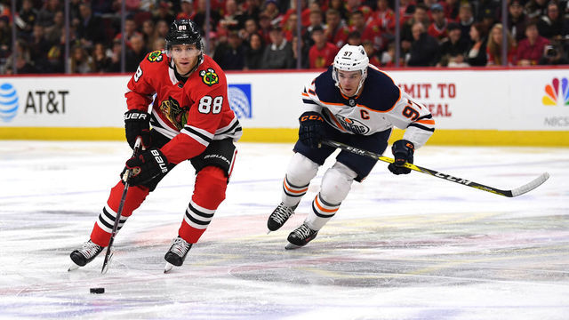 CHICAGO, IL - JANUARY 07: Chicago Blackhawks right wing Patrick Kane (88) controls the puck against Edmonton Oilers center Connor McDavid (97) during the first period during a game between the Chicago Blackhawks and the Edmonton Oilers on January 7, 2018, at the United Center in Chicago, IL.