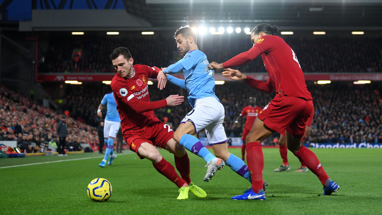 LIVERPOOL, ENGLAND - NOVEMBER 10: Bernardo Silva of Manchester City battles for possession with Virgil van Dijk and Andy Robertson of Liverpool during the Premier League match between Liverpool FC and Manchester City at Anfield on November 10, 2019 in Liverpool, United Kingdom.
