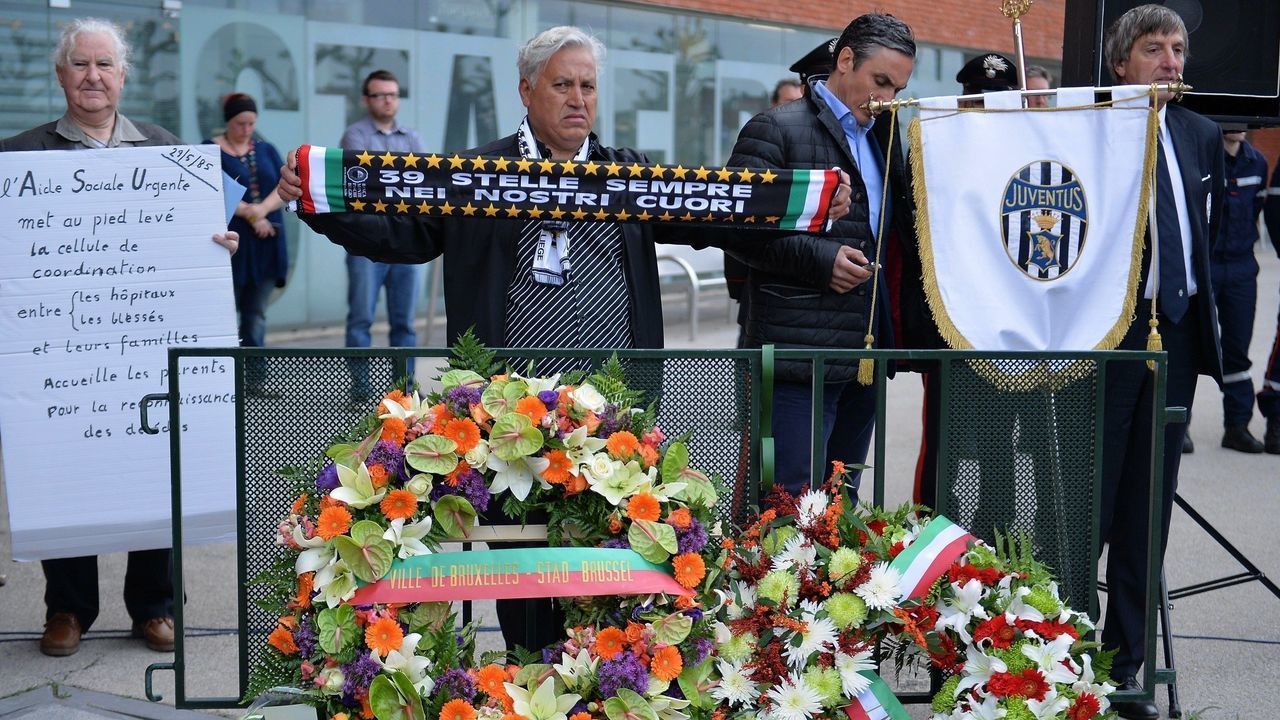 BRUSSELS, BELGIUM - MAY 29: People stand behind the wreaths during a ceremony marking the 30th anniversary of the tragedy at the stadium, renamed King Baudouin Stadium, in Brussels, on May 29, 2015. The Heysel disaster occurred before the start of the 1985 European Cup final Liverpool-Juventus when a wall collapsed under the pressure of escaping fans as result of riots before the start. 39 people died and 600 were injured.