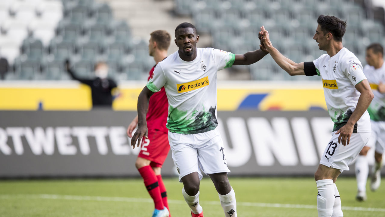 MOENCHENGLADBACH, GERMANY - MAY 23: Lars Stindl and Marcus Thuram of Borussia Moenchengladbach celebrate their first goal during the Bundesliga match between Borussia Moenchengladbach and Bayer 04 Leverkusen at Borussia-Park on May 23, 2020 in Moenchengladbach, Germany. The Bundesliga and Second Bundesliga is the first professional league to resume the season after the nationwide lockdown due to the ongoing Coronavirus (COVID-19) pandemic. All matches until the end of the season will be played behind closed doors