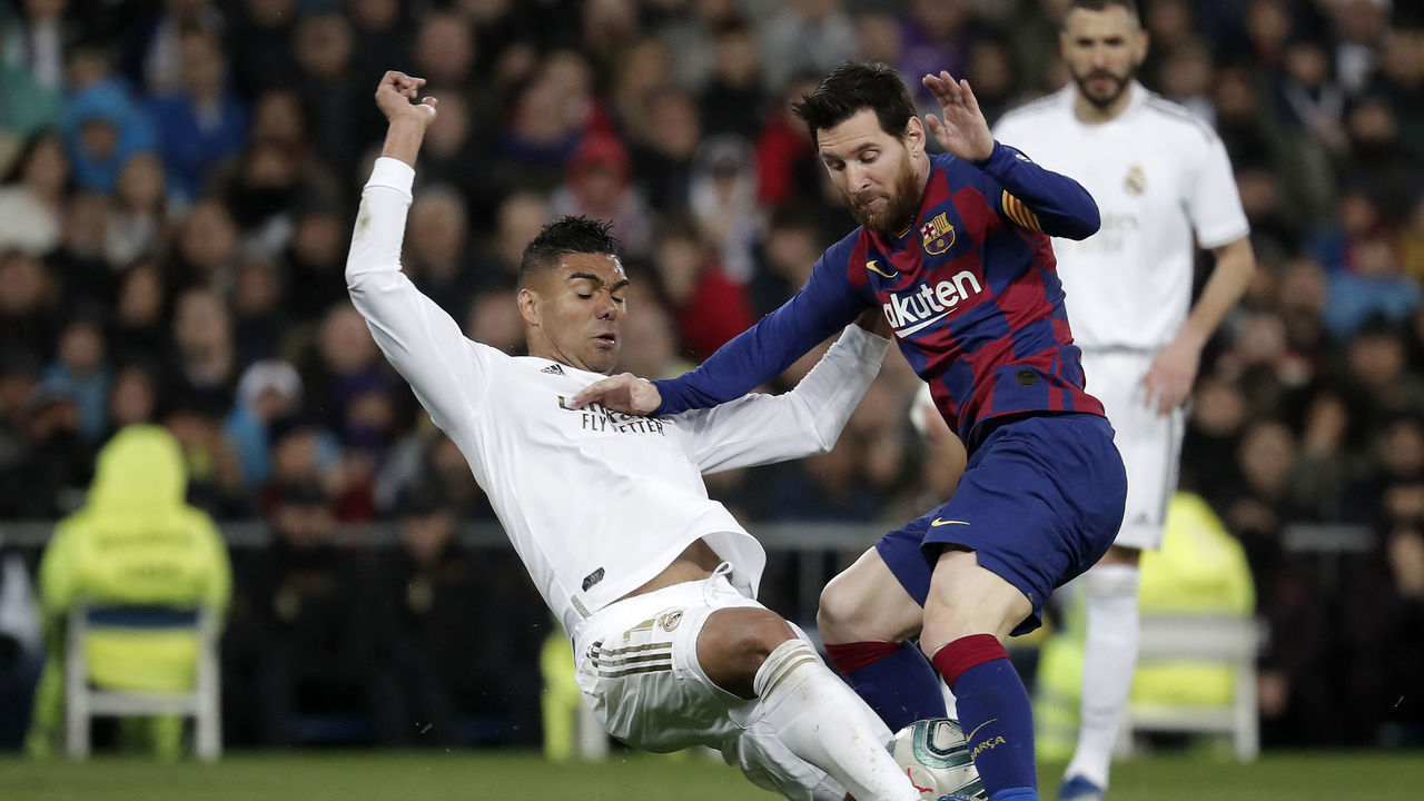 MADRID, SPAIN - MARCH 1: Carlos Casemiro of Real Madrid in action against Lionel Messi of Barcelona during the Spanish League football match between Real Madrid and Barcelona at the Santiago Bernabeu stadium in Madrid on March 1, 2020.