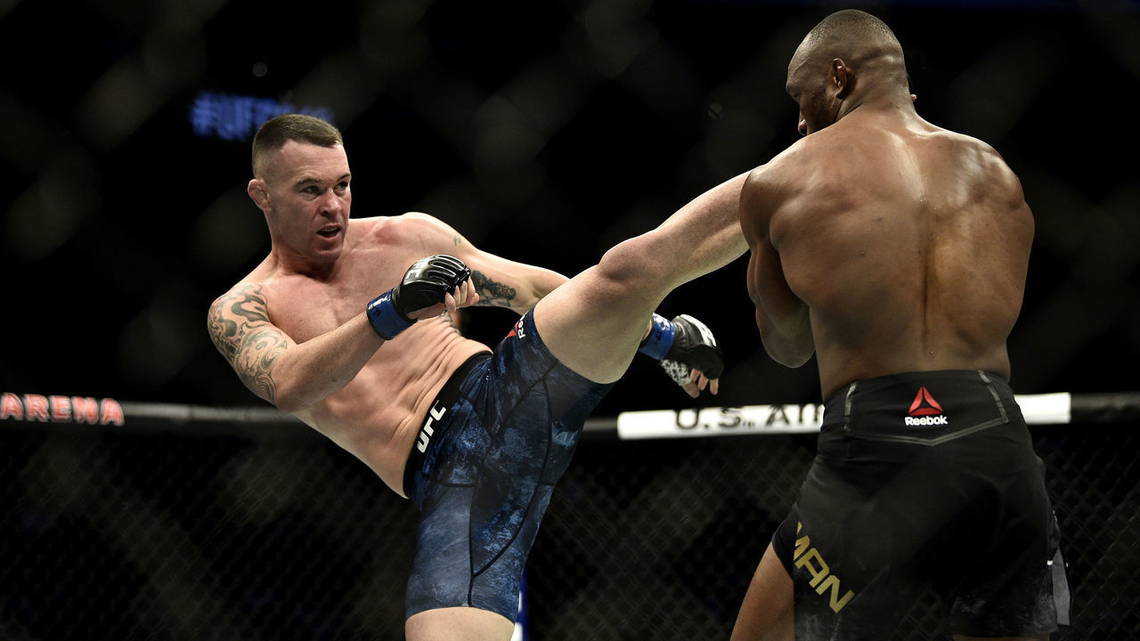 LAS VEGAS, NEVADA - DECEMBER 14: (L-R) Colby Covington kicks Kamaru Usman of Nigeria in their UFC welterweight championship bout during the UFC 245 event at T-Mobile Arena on December 14, 2019 in Las Vegas, Nevada.