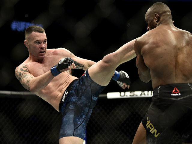 LAS VEGAS, NEVADA - DECEMBER 14: (L-R) Colby Covington kicks Kamaru Usman of Nigeria in their UFC welterweight championship bout during the UFC 245 event at T-Mobile Arena on December 14, 2019 in Las Vegas, Nevada.