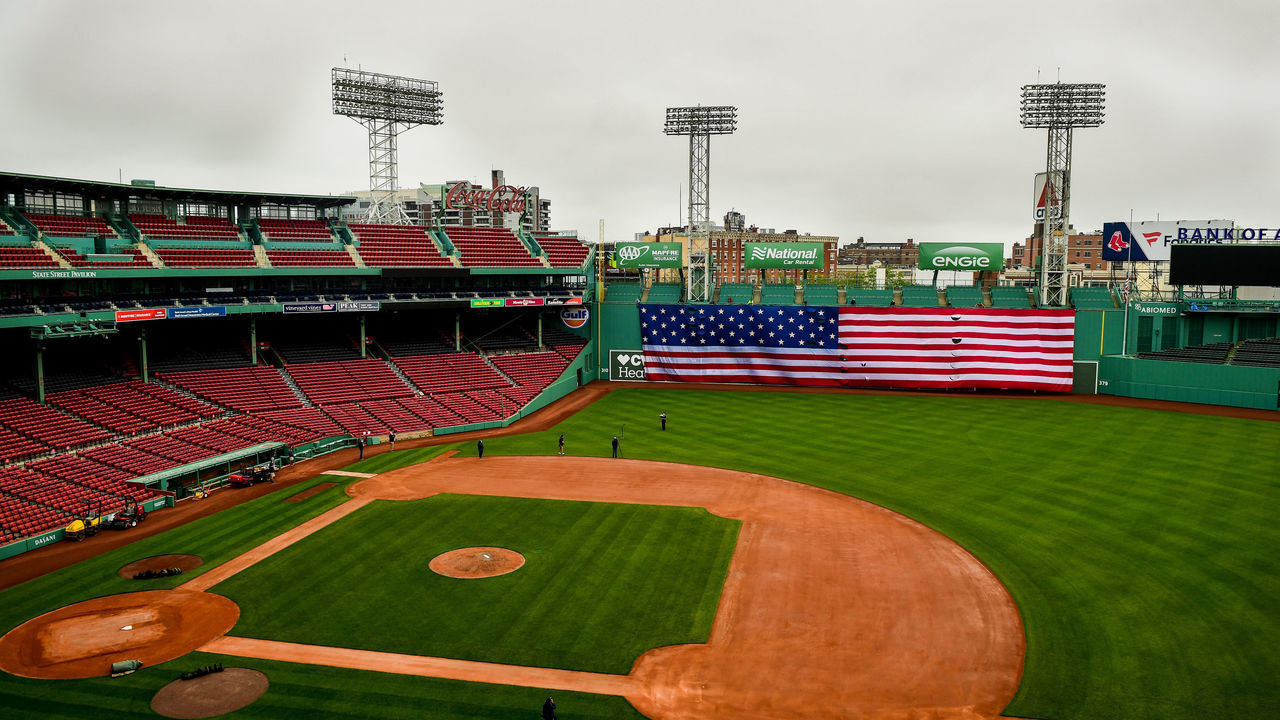 BOSTON, MA - MAY 25: The American flag is dropped over the Green Monster on Memorial Day as the Major League Baseball season is postponed due to the coronavirus pandemic on May 25, 2020 at Fenway Park in Boston, Massachusetts.