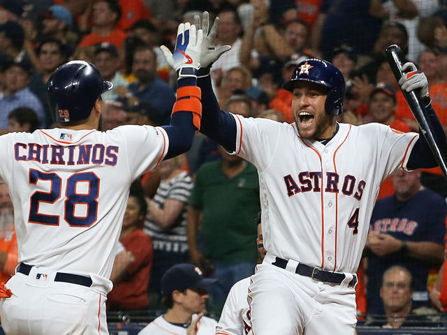HOUSTON, TEXAS - SEPTEMBER 09: Robinson Chirinos #28 of the Houston Astros receives a high five from George Springer #4 after hitting a home run in the first inning against the Oakland Athletics at Minute Maid Park on September 09, 2019 in Houston, Texas.