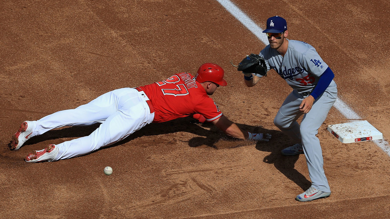 ANAHEIM, CA - JULY 07: Mike Trout #27 of the Los Angeles Angels of Anaheim dives back first base safely on a pick off attempt as Cody Bellinger #35 of the Los Angeles Dodgers defends during the first inning of a game at Angel Stadium on July 7, 2018 in Anaheim, California.