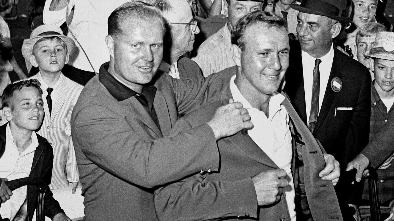 AUGUSTA, GA - APRIL 12: Jack Nicklaus (L) presents Arnold Palmer (R) with the green jacket during the Presentation Ceremony at the 1964 Masters Tournament at Augusta National Golf Club on April 9-12, 1964 in Augusta, Georgia.