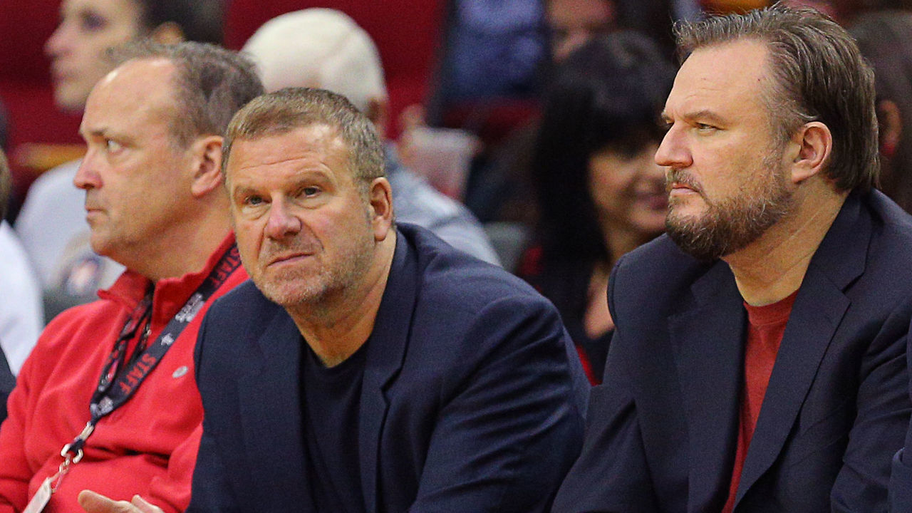 HOUSTON, TEXAS - OCTOBER 16: Tilman Fertitta, left, owner of the Houston Rockets and Daryl Morey, center, general manager sit courtside during a preseason game against the San Antonio Spurs at Toyota Center on October 16, 2019 in Houston, Texas. NOTE TO USER: User expressly acknowledges and agrees that, by downloading and/or using this photograph, user is consenting to the terms and conditions of the Getty Images License Agreement.