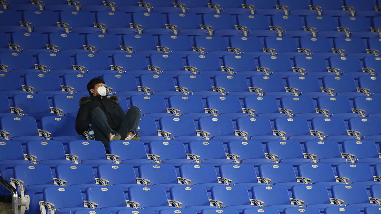 ULSAN, SOUTH KOREA - FEBRUARY 11: A fan in the stands wear a mask in light of novel coronavirus ahead of the AFC Champions League Group F match between Ulsan Hyundai and FC Tokyo at the Ulsan Munsu Football Stadium on February 11, 2020 in Ulsan, South Korea.