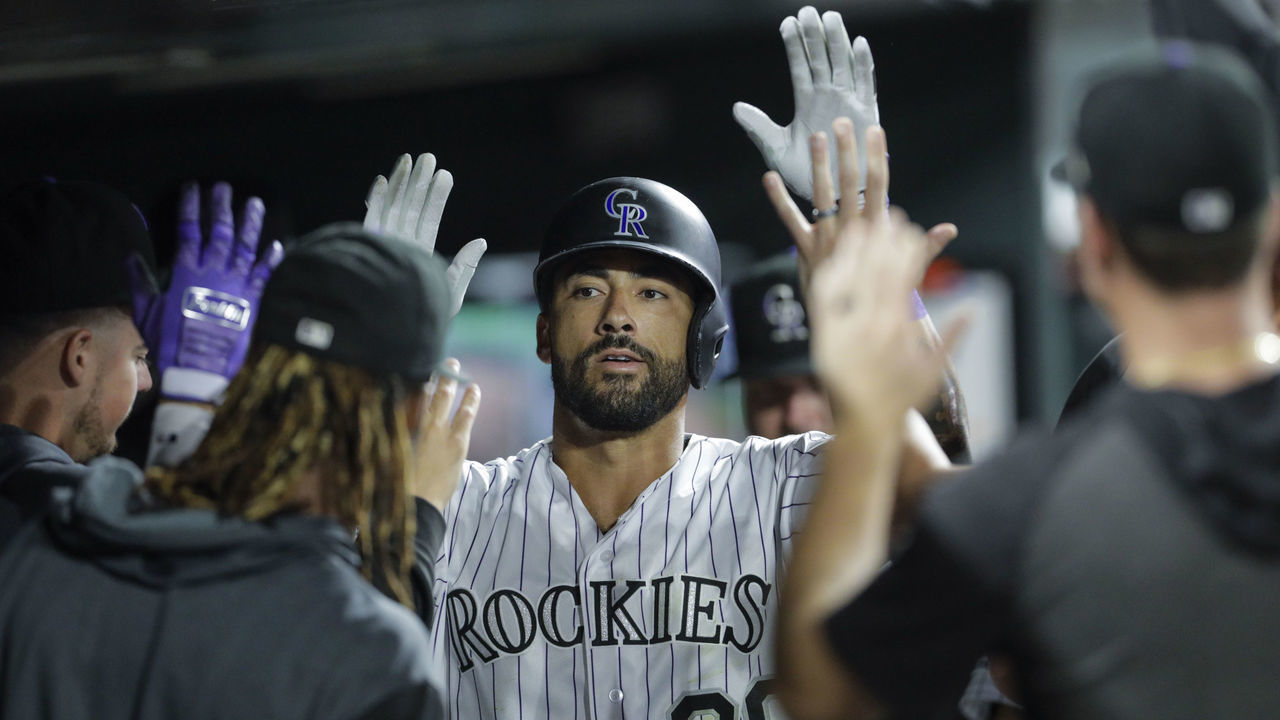 DENVER, CO - AUGUST 30: Ian Desmond #20 of the Colorado Rockies is congratulated in the dugout after his home run against the Pittsburgh Pirates in the eighth inning at Coors Field on August 30, 2019 in Denver, Colorado. Pittsburgh won 9-4.