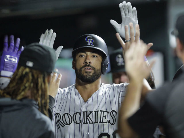 DENVER, CO - AUGUST 30: Ian Desmond #20 of the Colorado Rockies is congratulated in the dugout after his home run against the Pittsburgh Pirates in the eighth inning at Coors Field on August 30, 2019 in Denver, Colorado. Pittsburgh won 9-4.