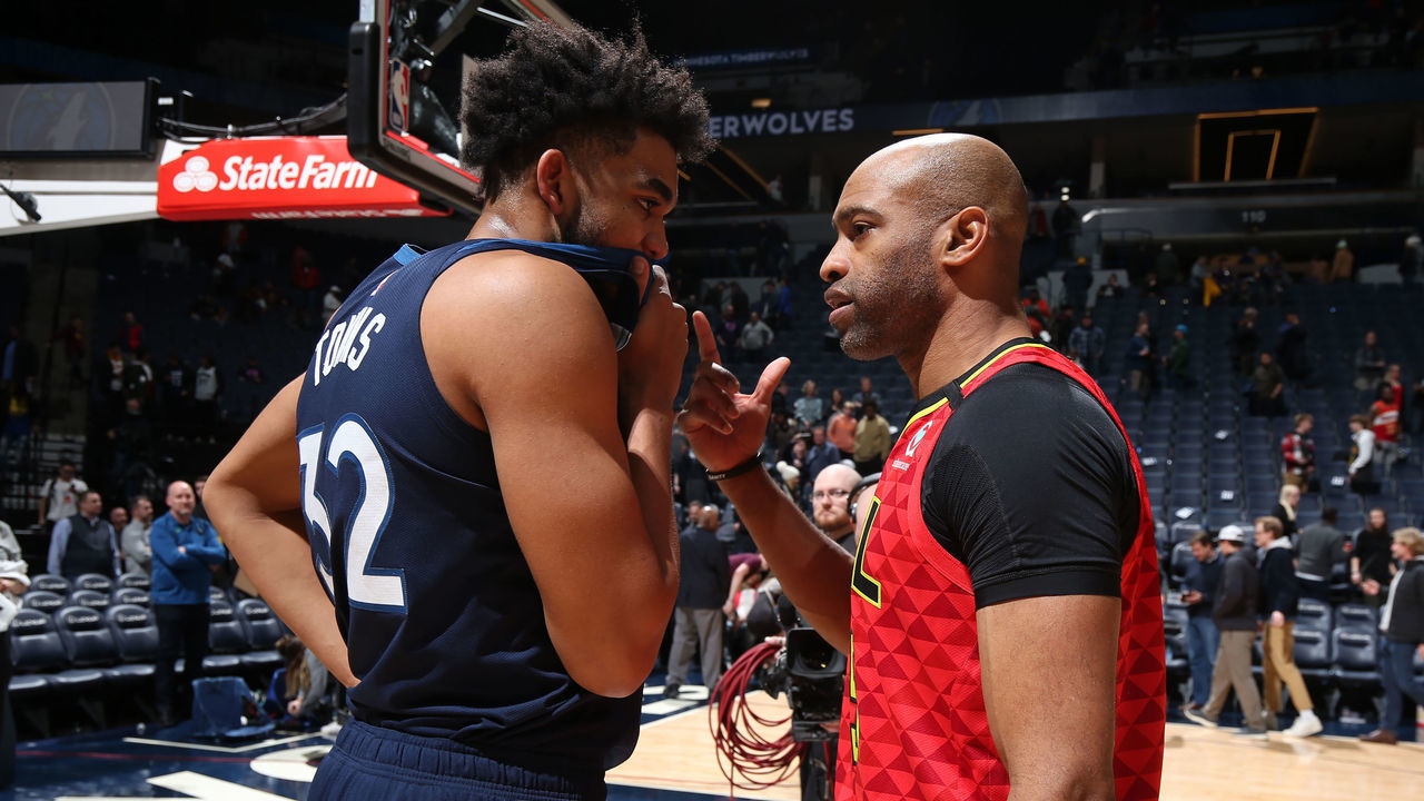 MINNEAPOLIS, MN - FEBRUARY 5: Karl-Anthony Towns #32 of the Minnesota Timberwolves shares a conversation with Vince Carter #15 of the Atlanta Hawks after the game on February 5, 2020 at Target Center in Minneapolis, Minnesota. Mandatory Copyright Notice: Copyright 2020 NBAE