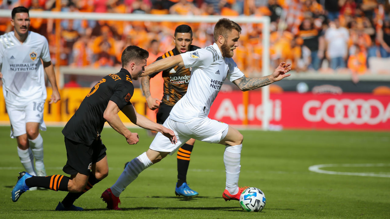 Houston TX - FEBRUARY 29: Los Angeles Galaxy midfielder Aleksandar Katai (7) dribbles the ball with Houston Dynamo defender Adam Lundqvist (3) in pursuit during the MLS match between the Los Angeles Galaxy and Houston Dynamo on February 29, 2020 at BBVA Stadium in Houston, Texas.