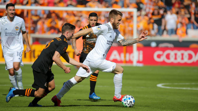 Houston TX - FEBRUARY 29: Los Angeles Galaxy midfielder Aleksandar Katai (7) dribbles the ball with Houston Dynamo defender Adam Lundqvist (3) in pursuit during the MLS match between the Los Angeles Galaxy and Houston Dynamo on February 29, 2020 at BBVA Stadium in Houston, Texas.