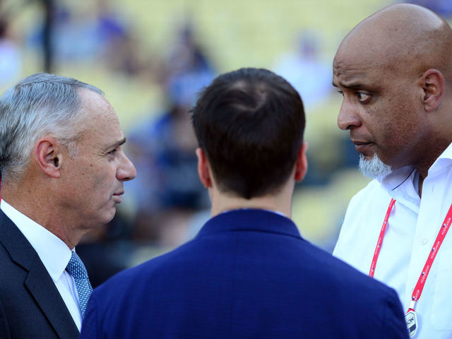 LOS ANGELES CA - OCTOBER 25 Major League Baseball Commissioner Robert D Manfred Jr talks with Executive Director of the Major League Baseball Players Association Tony Clark during batting practice prior to Game 2 of the 2017 World Series between the Houston Astros and the Los Angeles Dodgers at Dodger Stadium on Wednesday October 25 2017 in Los Angeles California