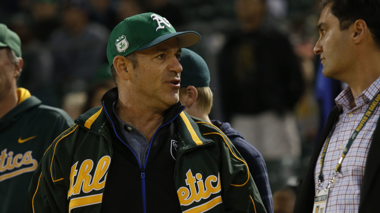 OAKLAND, CA - APRIL 21: Managing Partner John Fisher and President David Kaval of the Oakland Athletics talk in the stands during the game against the Seattle Mariners at the Oakland Alameda Coliseum on April 21, 2017 in Oakland, California. The Athletics defeated the Mariners 3-1.