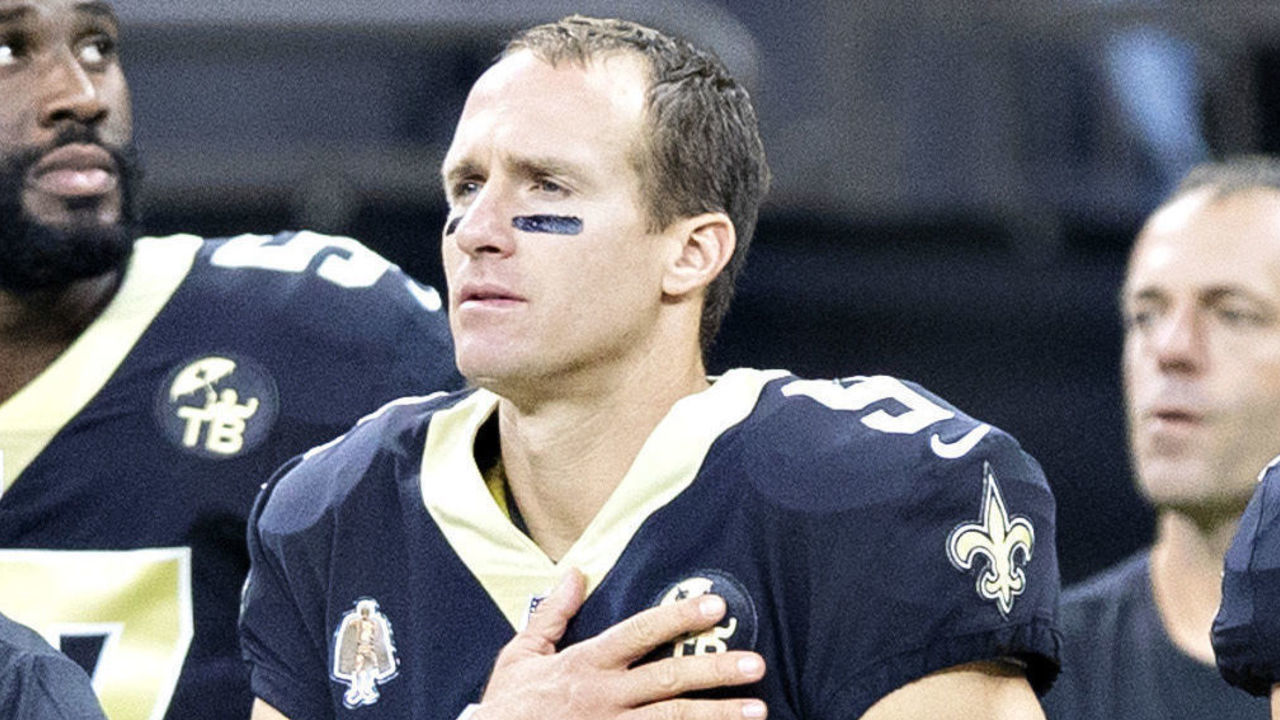 NEW ORLEANS, LA - AUGUST 30: Drew Brees #9 of the New Orleans Saints stands with his hand over his heart during the playing of the National Anthem before a game against the Los Angeles Rams at Mercedes-Benz Superdome during week 4 of the preseason on August 30, 2018 in New Orleans, Louisiana. The Saints defeated the Rams 28-0.