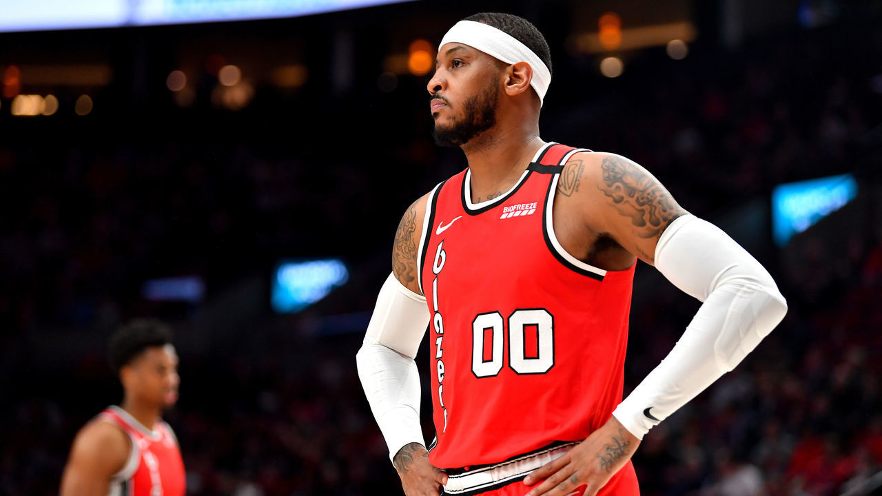 PORTLAND, OREGON - MARCH 10: Carmelo Anthony #00 of the Portland Trail Blazers (R) and Hassan Whiteside #21 look on during the second half of the game against the Phoenix Suns at the Moda Center on March 10, 2020 in Portland, Oregon. The Portland Trail Blazers topped the Phoenix Suns, 121-105.
