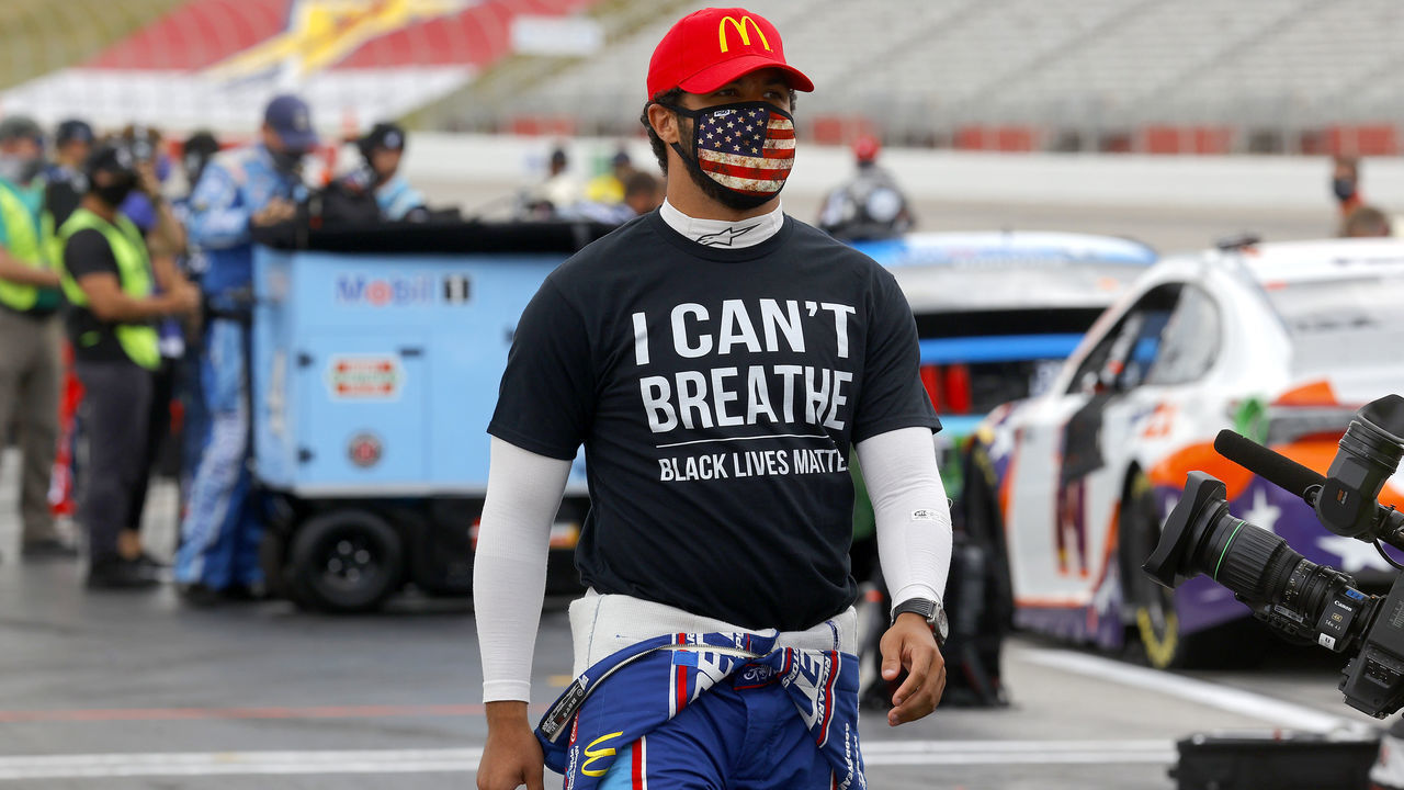 HAMPTON, GEORGIA - JUNE 07: Bubba Wallace, driver of the #43 McDonald's Chevrolet, wears a "I Can't Breath - Black Lives Matter" T-shirt under his fire suit in solidarity with protesters around the world taking to the streets after the death of George Floyd on May 25 while in the custody of Minneapolis, Minnesota police on the grid prior to the NASCAR Cup Series Folds of Honor QuikTrip 500 at Atlanta Motor Speedway on June 07, 2020 in Hampton, Georgia.