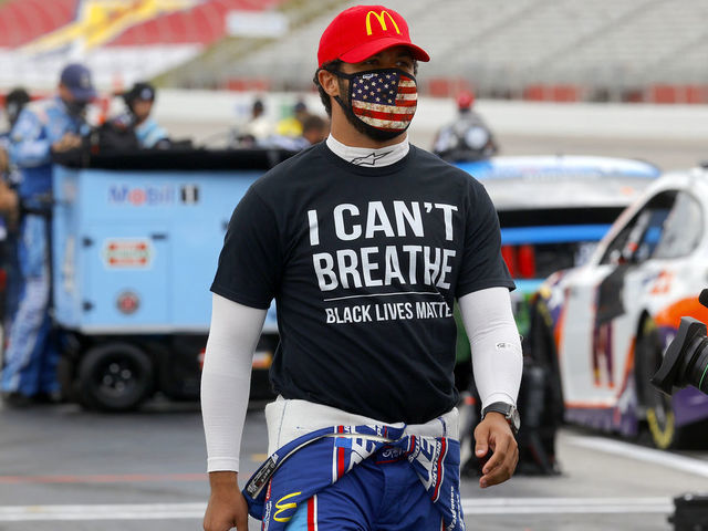 HAMPTON, GEORGIA - JUNE 07: Bubba Wallace, driver of the #43 McDonald's Chevrolet, wears a "I Can't Breath - Black Lives Matter" T-shirt under his fire suit in solidarity with protesters around the world taking to the streets after the death of George Floyd on May 25 while in the custody of Minneapolis, Minnesota police on the grid prior to the NASCAR Cup Series Folds of Honor QuikTrip 500 at Atlanta Motor Speedway on June 07, 2020 in Hampton, Georgia.