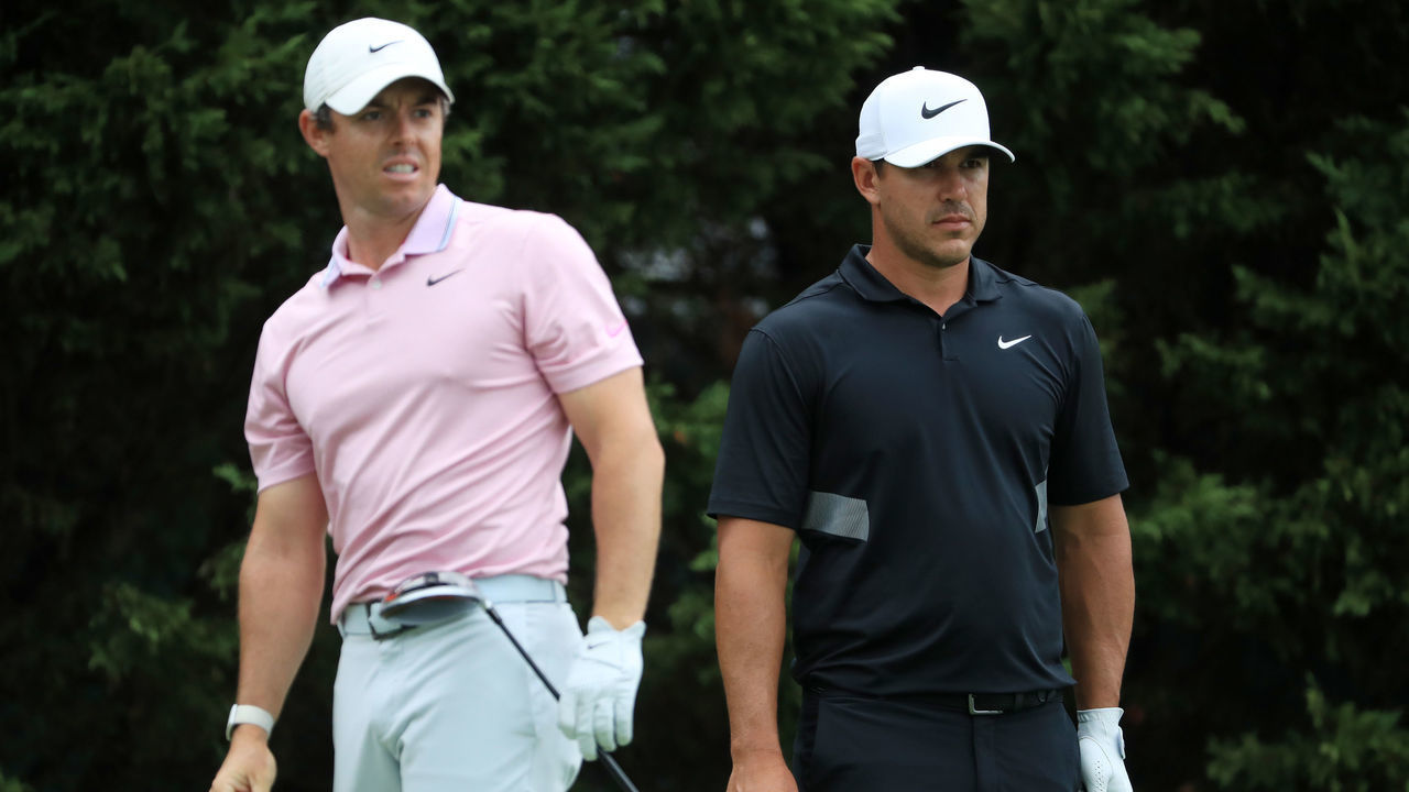 ATLANTA, GEORGIA - AUGUST 25: Brooks Koepka of the United States and Rory McIlroy of Northern Ireland look on from the eighth tee during the final round of the TOUR Championship at East Lake Golf Club on August 25, 2019 in Atlanta, Georgia.