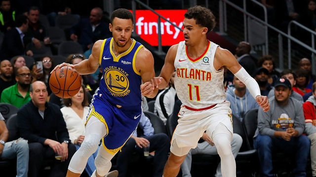 ATLANTA, GA - DECEMBER 03: Stephen Curry #30 of the Golden State Warriors drives against Trae Young #11 of the Atlanta Hawks at State Farm Arena on December 3, 2018 in Atlanta, Georgia.
