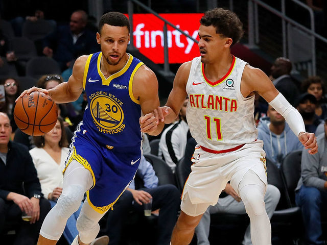 ATLANTA, GA - DECEMBER 03: Stephen Curry #30 of the Golden State Warriors drives against Trae Young #11 of the Atlanta Hawks at State Farm Arena on December 3, 2018 in Atlanta, Georgia.