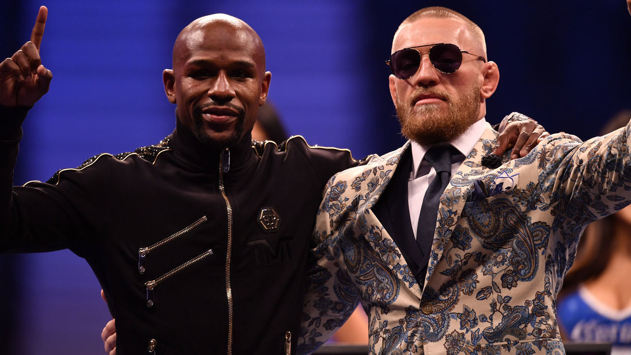 LAS VEGAS, NV - AUGUST 25: (L-R) Floyd Mayweather Jr. and Conor McGregor pose for pictures during a news conference after Mayweather's 10th-round TKO victory in their super welterweight boxing match on August 26, 2017 at T-Mobile Arena in Las Vegas, Nevada.