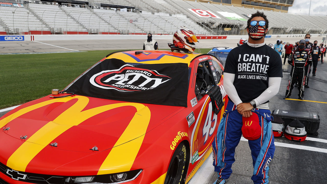 HAMPTON, GEORGIA - JUNE 07: Bubba Wallace, driver of the #43 McDonald's Chevrolet, wears a "I Can't Breath - Black Lives Matter" T-shirt under his fire suit in solidarity with protesters around the world taking to the streets after the death of George Floyd on May 25 while in the custody of Minneapolis, Minnesota police stands during the national anthem prior to the NASCAR Cup Series Folds of Honor QuikTrip 500 at Atlanta Motor Speedway on June 07, 2020 in Hampton, Georgia.