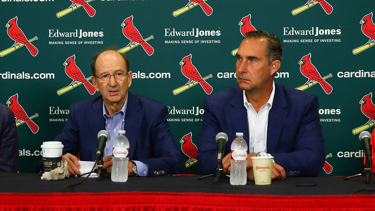ST. LOUIS, MO - JULY 15: (L to R) Mike Girsch, general manager of the St. Louis Cardinals; Bill DeWitt Jr., managing partner and chairman of the St. Louis Cardinals; John Mozeliak, President of Baseball Operations of the St. Louis Cardinals and Mike Schildt, interim manager of the St. Louis Cardinals addressing a change in the manager during a press conference prior to a game between the St. Louis Cardinals and the Cincinnati Reds at Busch Stadium on July 15, 2018 in St. Louis, Missouri.