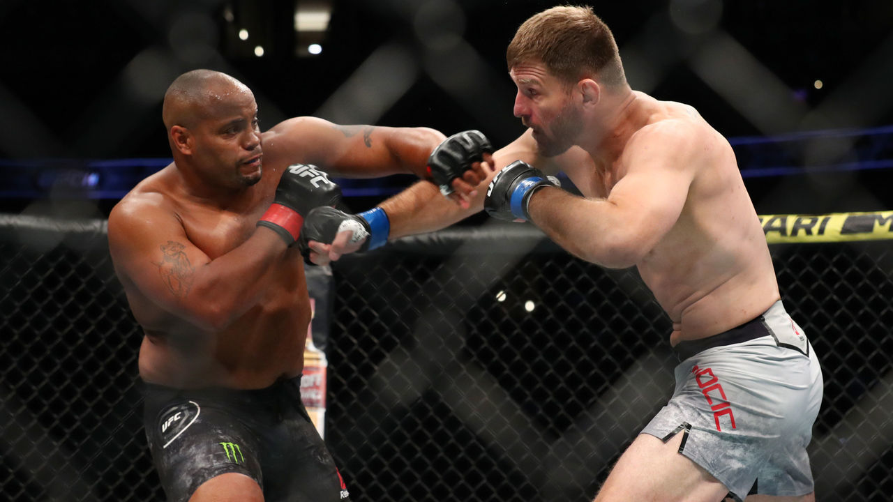 ANAHEIM, CALIFORNIA - AUGUST 17: Daniel Cormier throws a punch at Stipe Miocic in the first round during their UFC Heavyweight Title Bout at UFC 241 at Honda Center on August 17, 2019 in Anaheim, California.