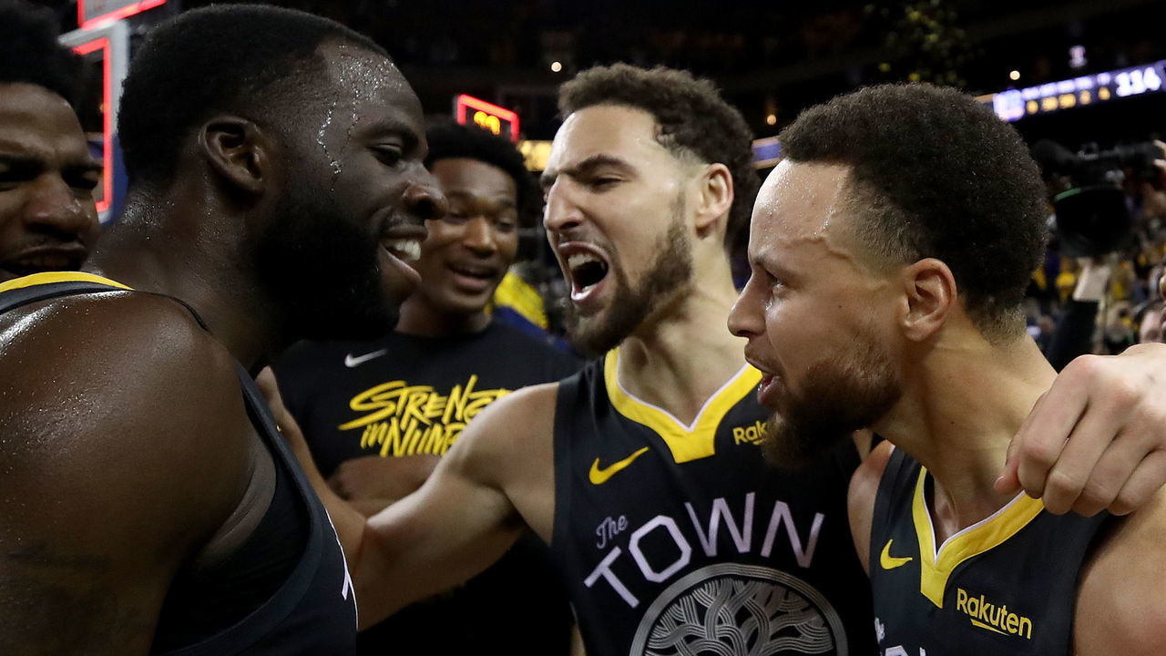 OAKLAND, CALIFORNIA - MAY 16: Stephen Curry #30, Klay Thompson #11 and Draymond Green #23 of the Golden State Warriors celebrate after defeating the Portland Trail Blazers 114-111 in game two of the NBA Western Conference Finals at ORACLE Arena on May 16, 2019 in Oakland, California.