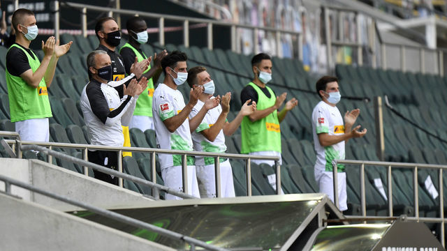MOENCHENGLADBACH, GERMANY - MAY 31: Moenchengladbach substitute players wearing face masks applaud after the Bundesliga match between Borussia Moenchengladbach and 1. FC Union Berlin at Borussia-Park on May 31, 2020 in Moenchengladbach, Germany.