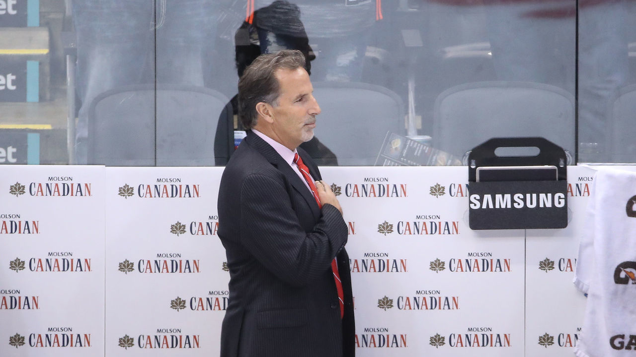 TORONTO, ON - SEPTEMBER 22: Assistant coach John Hynes of Team USA and head coach John Tortorella and assistant coach Phil Housley stand for the playing of the American national anthem before playing against Team Czech Republic during the World Cup of Hockey tournament at the Air Canada Centre on September 22, 2016 in Toronto, Canada.
