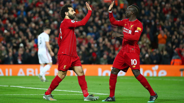 LIVERPOOL, ENGLAND - JANUARY 02: Mohamed Salah of Liverpool celebrates with Sadio Mane after scoring his team's first goal during the Premier League match between Liverpool FC and Sheffield United at Anfield on January 02, 2020 in Liverpool, United Kingdom.