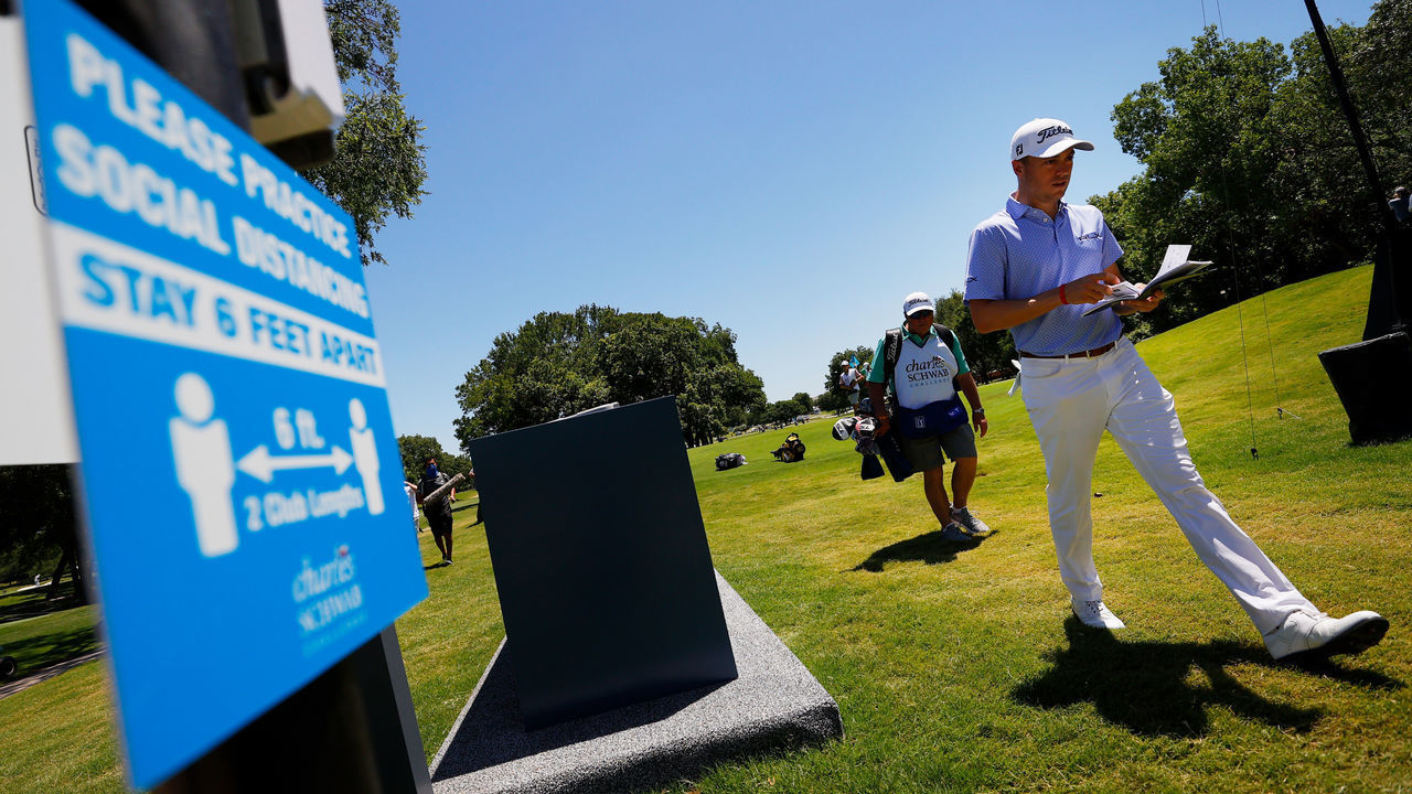 FORT WORTH, TEXAS - JUNE 11: Justin Thomas of the United States walks past social distancing signage on his way to the eighth tee during the first round of the Charles Schwab Challenge on June 11, 2020 at Colonial Country Club in Fort Worth, Texas.