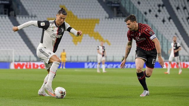 TURIN, ITALY - JUNE 12: Cristiano Ronaldo of Juventus is challenged by Alessio Romagnoli of AC Milan during the Coppa Italia Semi-Final Second Leg match between Juventus and AC Milan at Allianz Stadium on June 12, 2020 in Turin, Italy.
