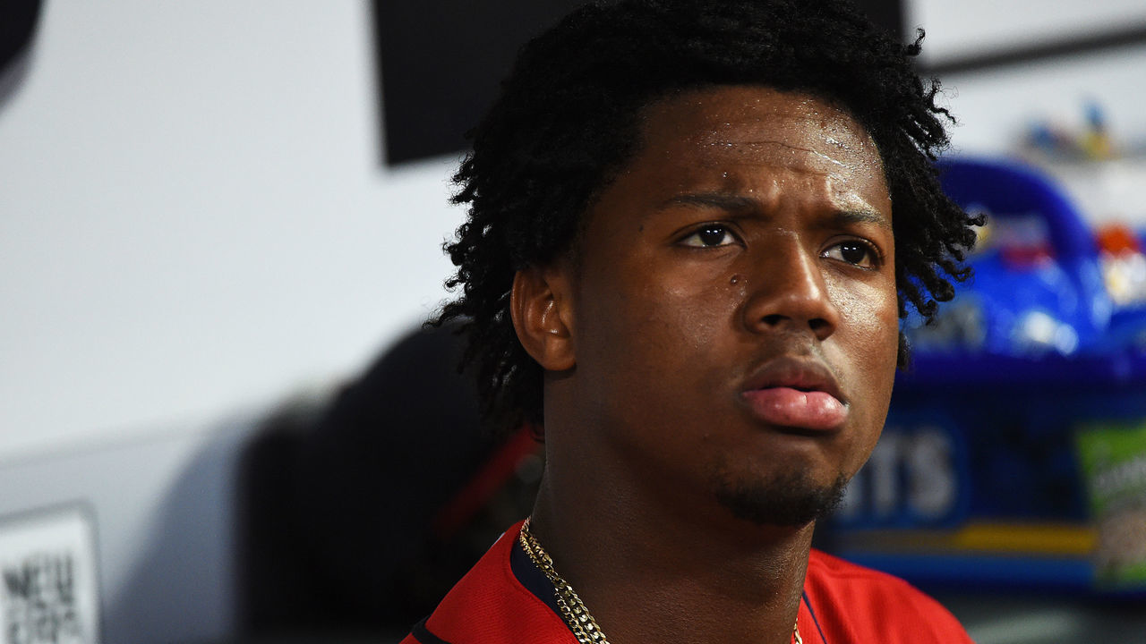 ATLANTA, GEORGIA - APRIL 05: Ronald Acuna Jr. #13 of the Atlanta Braves looks confused in the dugout against the Miami Marlins at SunTrust Park on April 05, 2019 in Atlanta, Georgia.