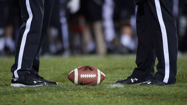 EVANSTON, IL - NOVEMBER 11: A detailed view of a Nike brand Purdue Boilermakers football rests between two referees standing in their Under Armour shoes is seen during the college football game between the against the Northwestern Wildcats and the against the Purdue Boilermakers on November 11, 2017, at Ryan Field in Evanston, IL.