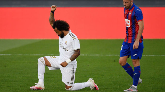 Real Madrid's Brazilian defender Marcelo kneels on the field to celebrate his goal during the Spanish League football match between Real Madrid CF and SD Eibar at the Alfredo di Stefano stadium in Valdebebas, on the outskirts of Madrid, on June 14, 2020.