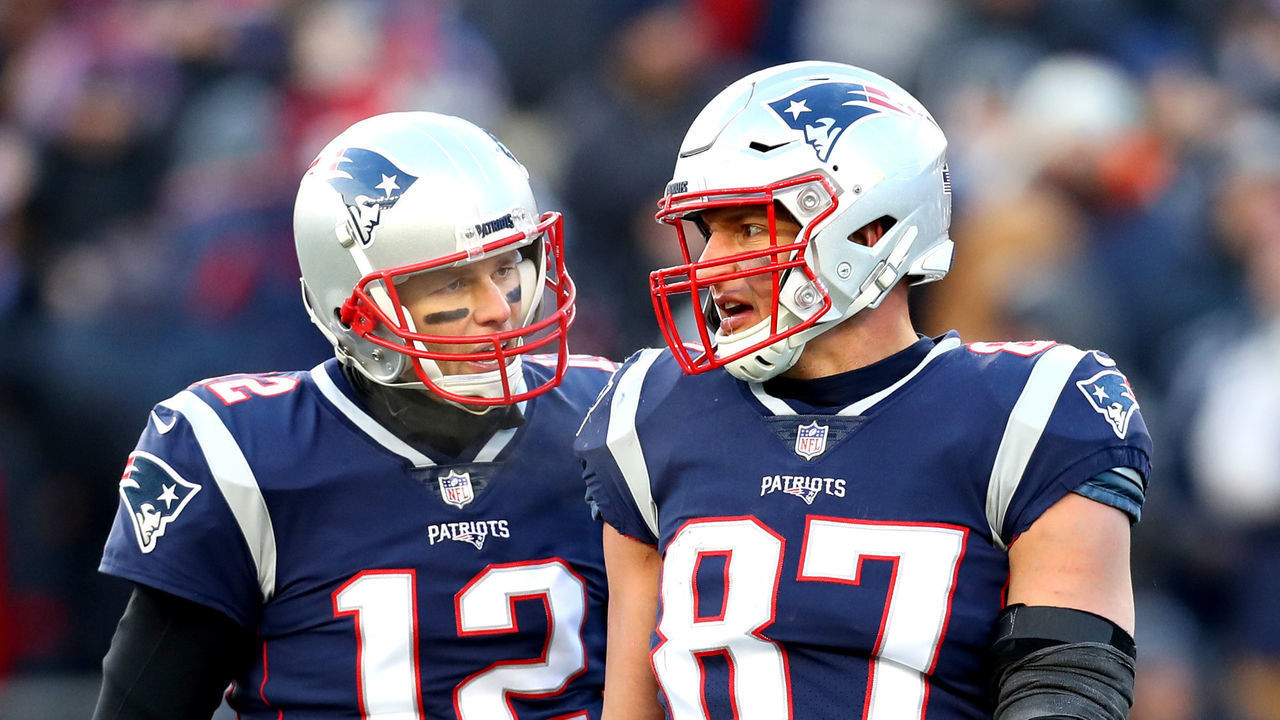 FOXBOROUGH, MASSACHUSETTS - JANUARY 13: Tom Brady #12 of the New England Patriots reacts with Rob Gronkowski #87 during the third quarter in the AFC Divisional Playoff Game against the Los Angeles Chargers at Gillette Stadium on January 13, 2019 in Foxborough, Massachusetts.