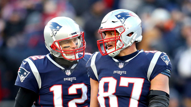 FOXBOROUGH, MASSACHUSETTS - JANUARY 13: Tom Brady #12 of the New England Patriots reacts with Rob Gronkowski #87 during the third quarter in the AFC Divisional Playoff Game against the Los Angeles Chargers at Gillette Stadium on January 13, 2019 in Foxborough, Massachusetts.