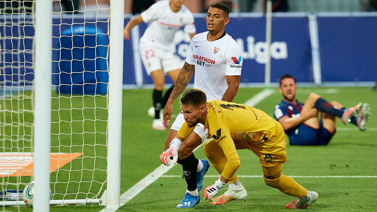 BENIDORM, SPAIN - JUNE 15: Tomas Vaclik (L) of Sevilla FC looks at the ball in the goal next to his teammate Diego Carlos (C) of Sevilla FC as Jorge Miramon (background) of Levante UD scores his side's first goal during the Liga match between Levante UD and Sevilla FC at Estadio Camilo Cano on June 15, 2020 in Benidorm, Spain.