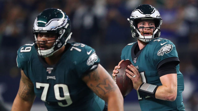 ARLINGTON, TEXAS - OCTOBER 20: Carson Wentz #11 of the Philadelphia Eagles looks to pass as Brandon Brooks #79 blocks during the first half against the Dallas Cowboys in the game at AT&T Stadium on October 20, 2019 in Arlington, Texas.